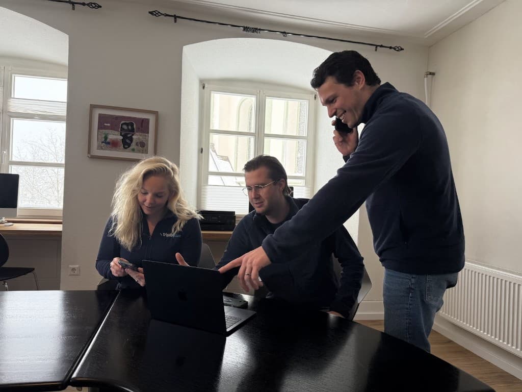 Colleagues collaborating with phone and laptop