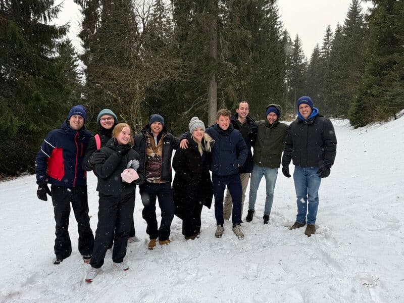 Team in snowy forest, Southern Germany